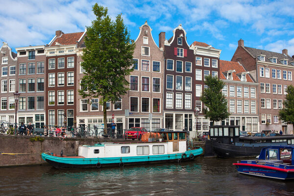 Traditional old houses and boats on Amsterdam canal