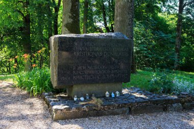 Chistye Prudy, Russian Federation - June 19, 2019: Memorial stone dedicated to famous lithuanian author Kristijonas Donelaitis near Lutheran church of Tollmingkehmen.