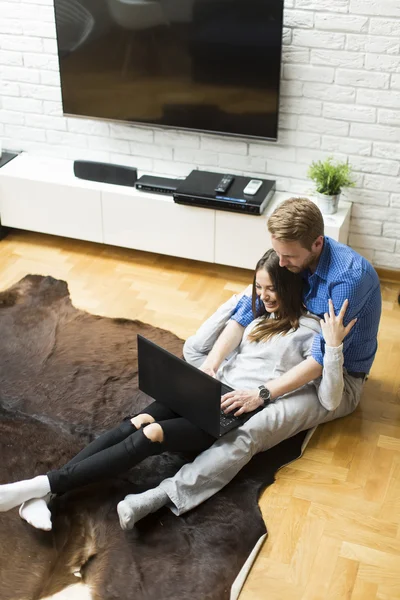 Casal com um laptop em casa — Fotografia de Stock