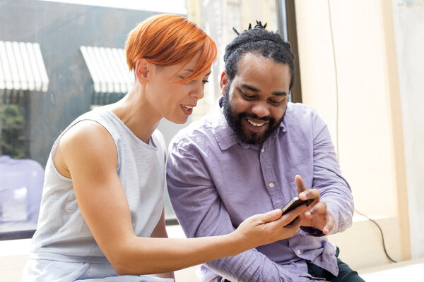 Multiracial couple using smartphone
