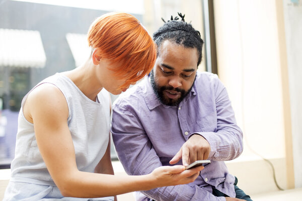 Multiracial couple using smartphone