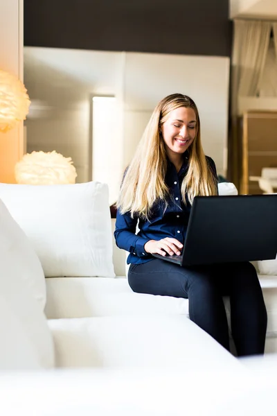 Young woman on a sofa — Stock Photo, Image