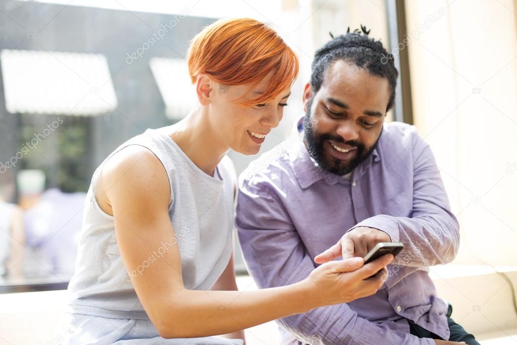 Multiracial couple using smartphone