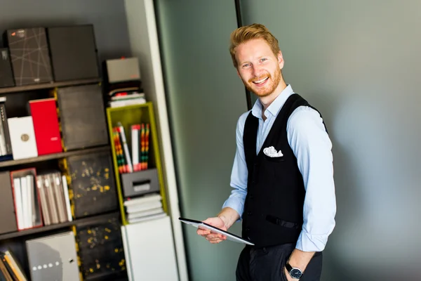 Businessman with a tablet in the office — Stock Photo, Image