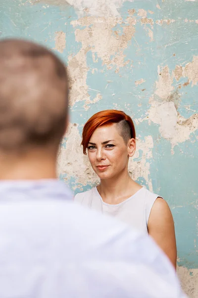 Young woman by the wall — Stock Photo, Image