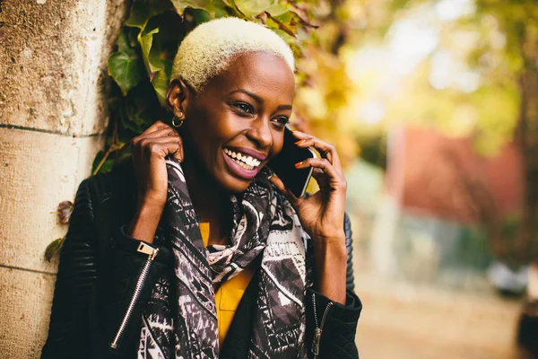 Young african american woman with smartphone Stock Image