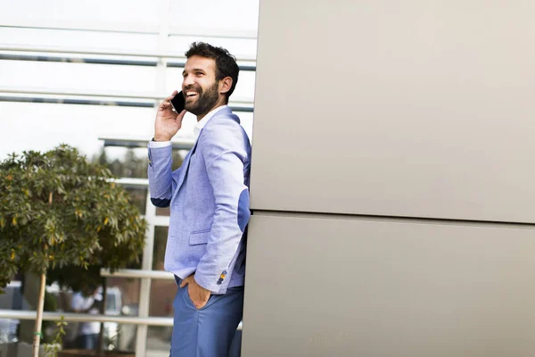 Modern businessman with phone in office — Stock Photo, Image