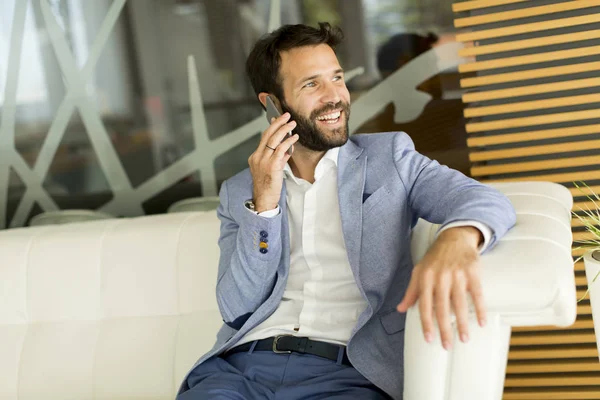 Moderna affärsman med telefon i office — Stockfoto