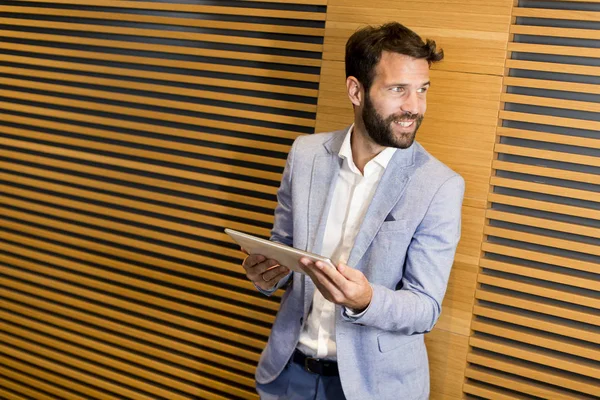 Homme d'affaires moderne avec tablette au bureau — Photo