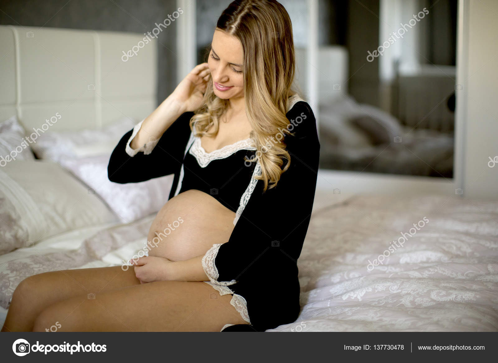 Young pregnant woman in bed Stock Photo by ©boggy22 137730478