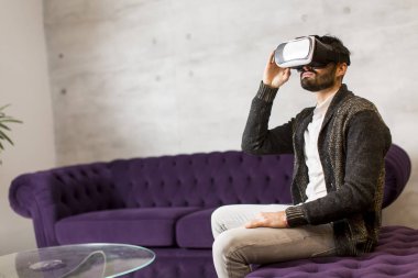 Adam sanal gerçeklik gözlüğü takıyor.