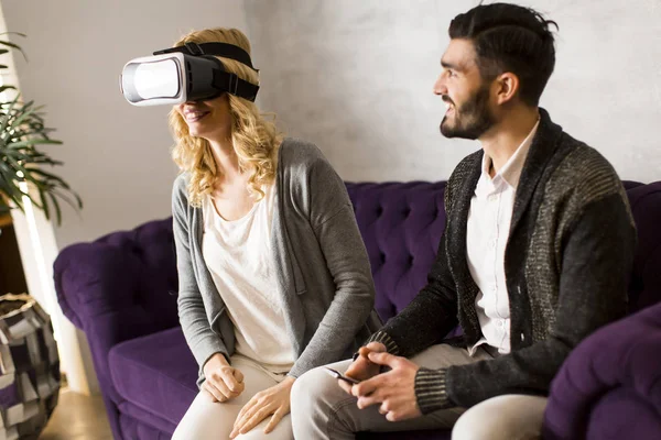 Woman with reality glasses while man sitting — Stock Photo, Image