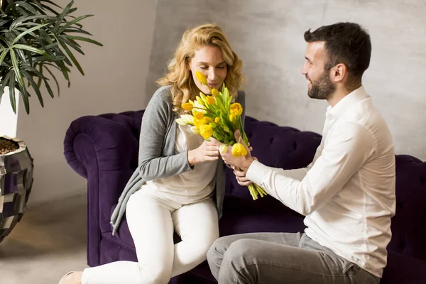 Hombre dando a chica un ramo de tulipanes — Foto de Stock