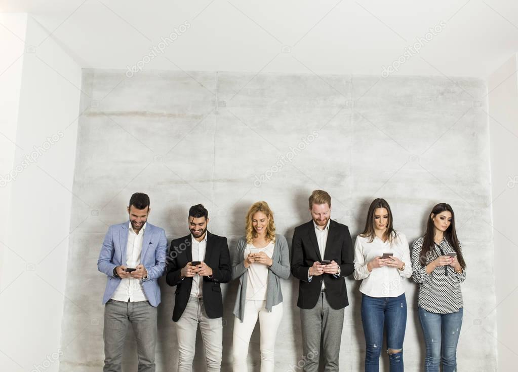 Young business people with mobile phones