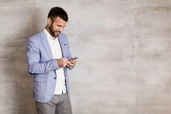 Modern businessman with phone in office