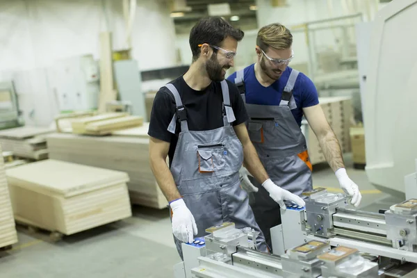 Young men working in lumber workshop — Stock Photo, Image