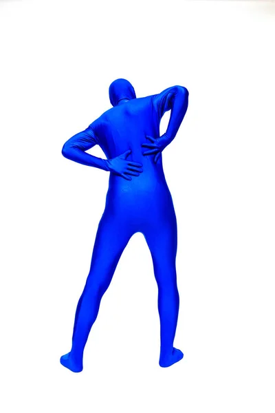 Man in morphsuit has back pain — Stock Photo, Image