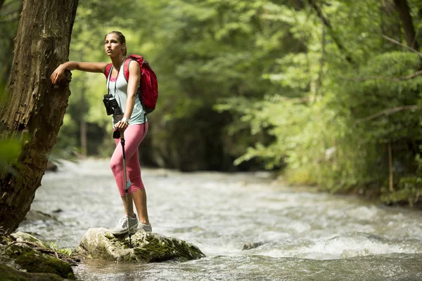 Woman hiking by the river — Stock Photo, Image