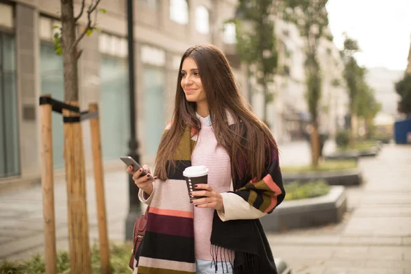 Frau mit Telefon und Kaffee im Freien — Stockfoto