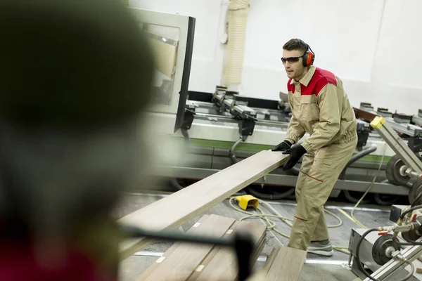 Young worker in a factory — Stock Photo, Image