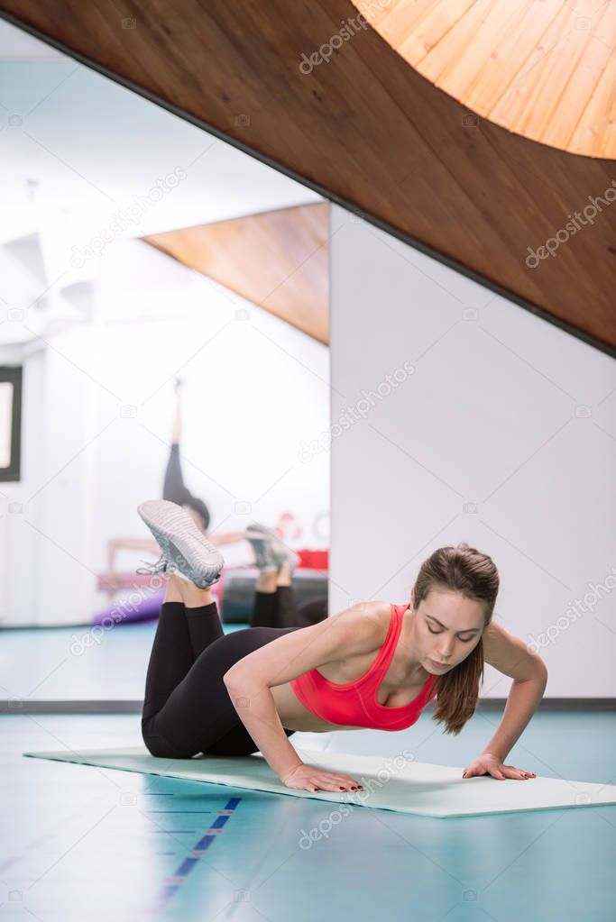 Woman doing exercises in gym