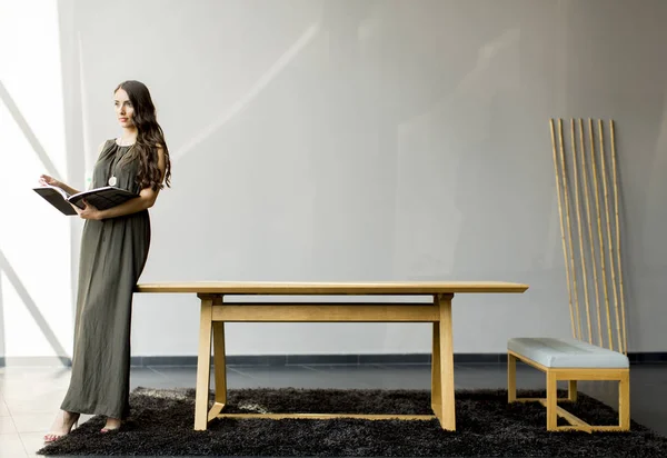 Jovem mulher lendo no quarto — Fotografia de Stock