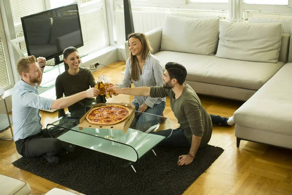 Friends eating pizza in the modern interior