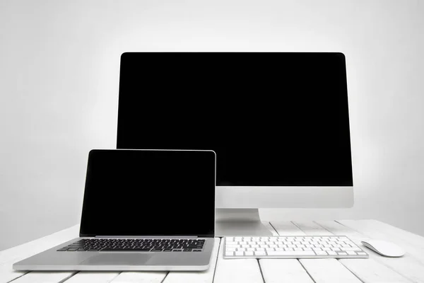 Computer and laptop on table — Stock Photo, Image