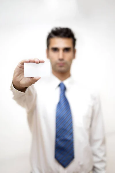 Businessman holding white business card in his hand — Stock Photo, Image