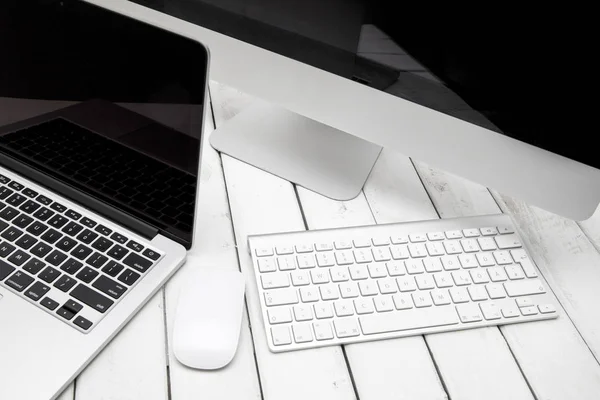 Computer and laptop on table — Stock Photo, Image