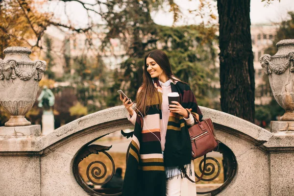 Frau mit Telefon und Kaffee im Freien — Stockfoto