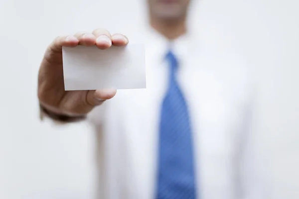 Businessman holding white business card in his hand — Stock Photo, Image