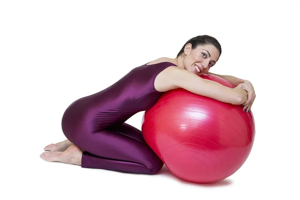 Woman exercises with red pilates ball — Stock Photo, Image