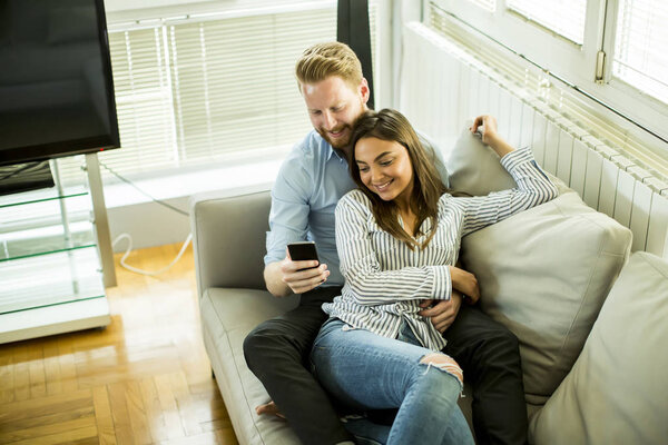 Couple in the room with mobile phone