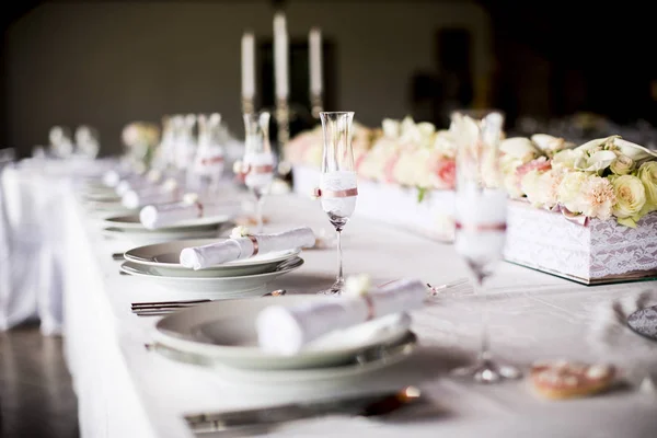 Nádherně zdobené svatební stůl s kyticí růží — Stock fotografie