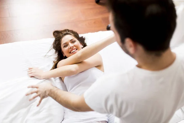 Couple having fun in bed — Stock Photo, Image