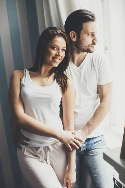 Loving couple by the window — Stock Photo, Image