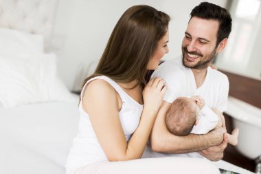 Yeni doğmuş bebeğiyle mutlu bir aile 