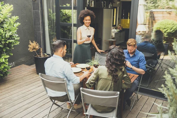 Young people enjoy the food in backyard