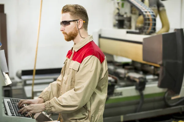 Young worker in a factory — Stock Photo, Image