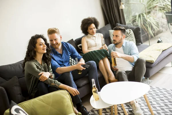 Grupo de amigos assistindo TV, beber cidra e se divertir — Fotografia de Stock