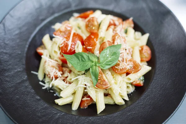 Penne pasta with cheese and cherry tomatoes — Stock Photo, Image