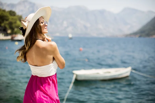 Joven mujer atractiva posa junto al mar — Foto de Stock