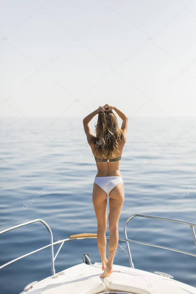 Pretty woman relaxing on the yacht