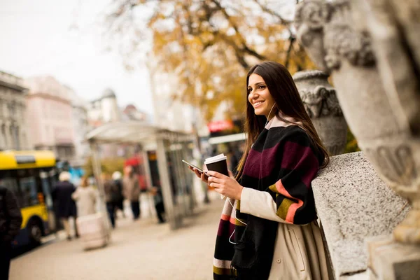 Pretty young woman on the street at autumn day — Stock Photo, Image