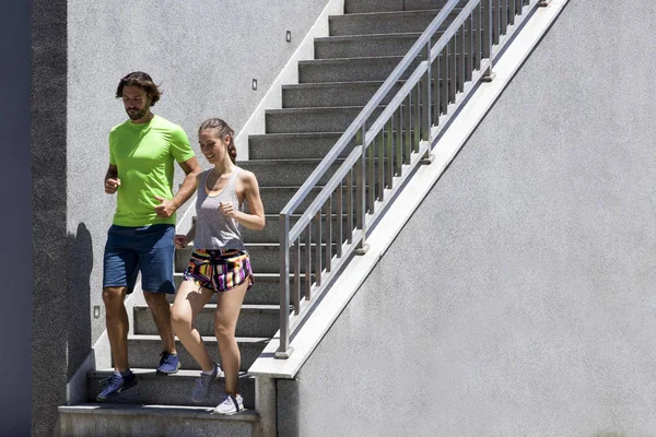 Handsome man and beautiful woman jogging together