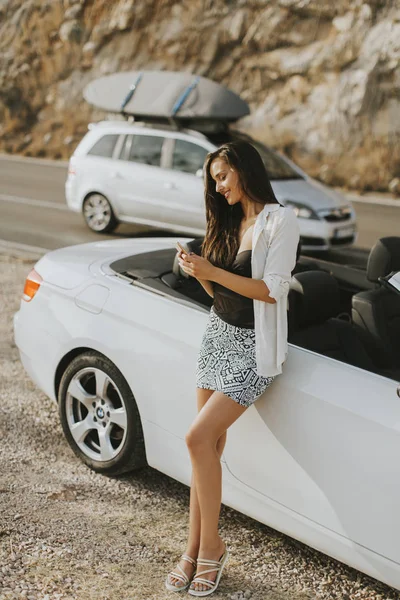 Mujer bonita por cabriolet blanco coche — Foto de Stock