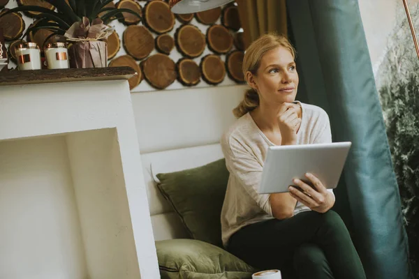 Mooie jonge vrouw met tablet in het café — Stockfoto