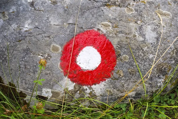 Red and white circle trail blazing sign