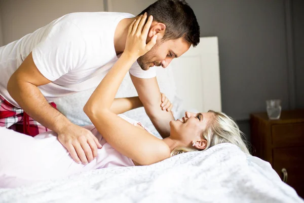 Lovely young couple in the bed Royalty Free Stock Images
